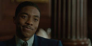 Movie still from “Marshall” (2017), directed by Reginald Hudlin – A person wearing a suit and tie; Close Up shot, Over the shoulder angle