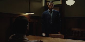 Movie still from “Marshall” (2017), directed by Reginald Hudlin – A man standing in front of a table in a room; Medium shot, Over the shoulder angle