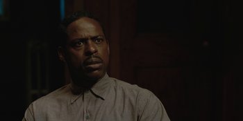 Movie still from “Marshall” (2017), directed by Reginald Hudlin – A man in a gray shirt is looking at the camera; Close Up shot, Low angle