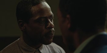 Movie still from “Marshall” (2017), directed by Reginald Hudlin – A man sitting next to another man in front of a window; Close Up shot, Over the shoulder angle