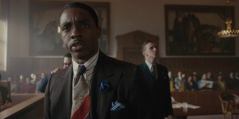 Movie still from “Marshall” (2017), directed by Reginald Hudlin – A man in a suit standing in front of another man in a suit; Close Up shot, Low angle