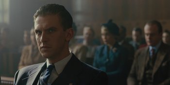 Movie still from “Marshall” (2017), directed by Reginald Hudlin – A man wearing a suit and tie in front of a crowd; Close Up shot, Over the shoulder angle