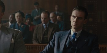 Movie still from “Marshall” (2017), directed by Reginald Hudlin – A man in a suit standing in front of a group of people; Close Up shot, Low angle