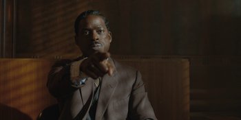 Movie still from “Marshall” (2017), directed by Reginald Hudlin – A man in a suit and tie holding a pipe; Close Up shot, Low angle