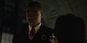 Movie still from “Marshall” (2017), directed by Reginald Hudlin – A man in a suit and tie looking at the camera; Close Up shot, Over the shoulder angle
