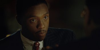 Movie still from “Marshall” (2017), directed by Reginald Hudlin – A person wearing a suit and tie; Close Up shot, High angle