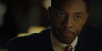 Movie still from “Marshall” (2017), directed by Reginald Hudlin – A person wearing a suit and tie; Close Up shot, Over the shoulder angle