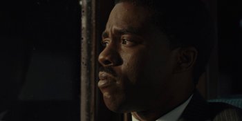 Movie still from “Marshall” (2017), directed by Reginald Hudlin – A man's face in the dark; Close Up shot, Low angle