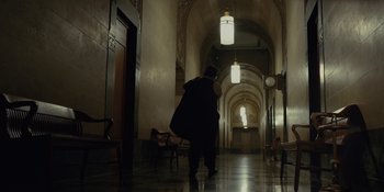 Movie still from “Marshall” (2017), directed by Reginald Hudlin – A man walking down a hallway in a building; Extreme Wide shot, Low angle