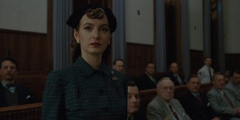 Movie still from “Marshall” (2017), directed by Reginald Hudlin – A woman wearing a hat standing in front of a group of people; Close Up shot, Low angle