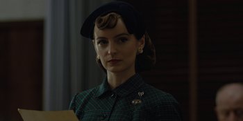 Movie still from “Marshall” (2017), directed by Reginald Hudlin – A woman in a green plaid shirt wearing a black hat; Close Up shot, Over the shoulder angle
