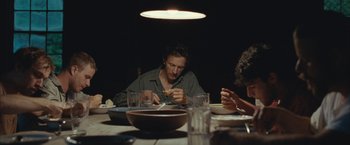 Movie still from “Martha Marcy May Marlene” (2011), directed by Sean Durkin – A group of people sitting at a dinner table eating food; Medium shot, Over the shoulder angle