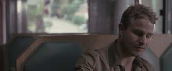 Movie still from “Martha Marcy May Marlene” (2011), directed by Sean Durkin – A man sitting in front of a window; Close Up shot, Over the shoulder angle