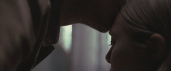 Movie still from “Martha Marcy May Marlene” (2011), directed by Sean Durkin – A man touching the forehead of a woman's face; Extreme Close Up shot, Over the shoulder angle