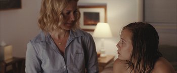 Movie still from “Martha Marcy May Marlene” (2011), directed by Sean Durkin – A woman talking to a young girl in a living room; Medium shot, Over the shoulder angle