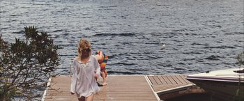 Movie still from “Martha Marcy May Marlene” (2011), directed by Sean Durkin – Two people on a dock near the water; Wide shot, High angle