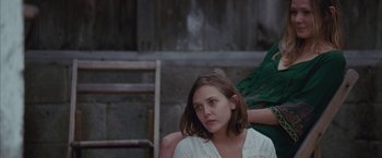 Movie still from “Martha Marcy May Marlene” (2011), directed by Sean Durkin – A woman sitting in front of another woman; Medium shot, Over the shoulder angle