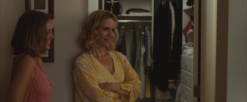 Movie still from “Martha Marcy May Marlene” (2011), directed by Sean Durkin – A woman standing in front of an open closet; Medium shot, Over the shoulder angle