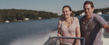 Movie still from “Martha Marcy May Marlene” (2011), directed by Sean Durkin – A woman sitting on the front end of a boat in the water; Medium shot, Over the shoulder angle