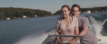 Movie still from “Martha Marcy May Marlene” (2011), directed by Sean Durkin – A man and a woman riding a boat on a lake; Medium shot, Low angle