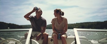 Movie still from “Martha Marcy May Marlene” (2011), directed by Sean Durkin – A man and a woman sitting on the back of a boat; Medium shot, Over the shoulder angle