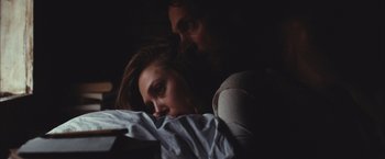 Movie still from “Martha Marcy May Marlene” (2011), directed by Sean Durkin – A man and a woman in a dark room; Close Up shot, Over the shoulder angle