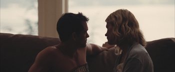 Movie still from “Martha Marcy May Marlene” (2011), directed by Sean Durkin – A man and a woman sitting next to each other on a couch; Close Up shot, Low angle