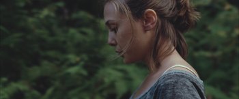 Movie still from “Martha Marcy May Marlene” (2011), directed by Sean Durkin – A person with long hair; Close Up shot, High angle