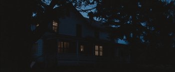 Movie still from “Martha Marcy May Marlene” (2011), directed by Sean Durkin – A house that has been lit up at night; Extreme Wide shot, Low angle