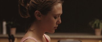 Movie still from “Martha Marcy May Marlene” (2011), directed by Sean Durkin – A young girl is looking to her left; Close Up shot, Over the shoulder angle