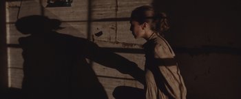 Movie still from “Martha Marcy May Marlene” (2011), directed by Sean Durkin – A woman standing in front of a brick wall; Medium shot, Over the shoulder angle