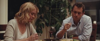 Movie still from “Martha Marcy May Marlene” (2011), directed by Sean Durkin – A man and a woman sitting at a dinner table; Medium shot, Over the shoulder angle