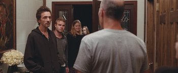 Movie still from “Martha Marcy May Marlene” (2011), directed by Sean Durkin – A man and two women standing in front of an open door; Medium shot, Over the shoulder angle