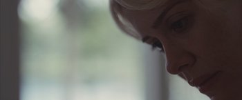 Movie still from “Martha Marcy May Marlene” (2011), directed by Sean Durkin – A woman's face with her eyes closed; Extreme Close Up shot, Over the shoulder angle