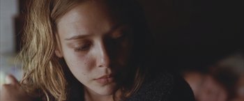 Movie still from “Martha Marcy May Marlene” (2011), directed by Sean Durkin – A person with her eyes closed; Close Up shot, Low angle