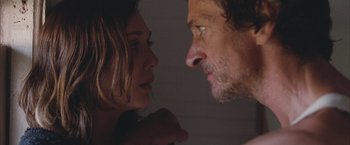 Movie still from “Martha Marcy May Marlene” (2011), directed by Sean Durkin – A man and a woman face to face in a room; Close Up shot, Over the shoulder angle