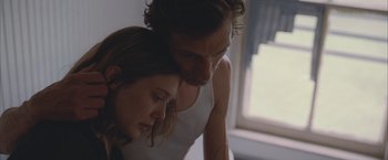 Movie still from “Martha Marcy May Marlene” (2011), directed by Sean Durkin – A man and a woman looking at each other in front of a window; Close Up shot, Over the shoulder angle