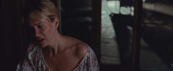 Movie still from “Martha Marcy May Marlene” (2011), directed by Sean Durkin – A woman in a white dress is looking at a man in a black suit; Close Up shot, Over the shoulder angle