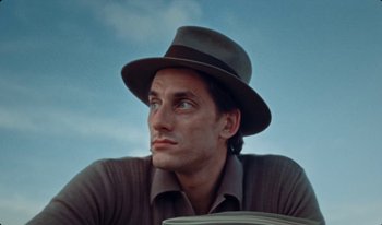 Movie still from “Martin Eden” (2019), directed by Pietro Marcello – A person wearing a hat; Close Up shot, Low angle