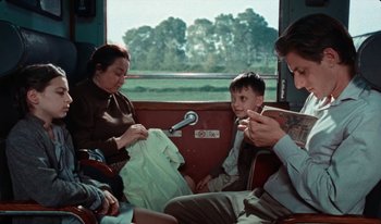 Movie still from “Martin Eden” (2019), directed by Pietro Marcello – A group of people sitting on top of a bus; Medium shot, Over the shoulder angle