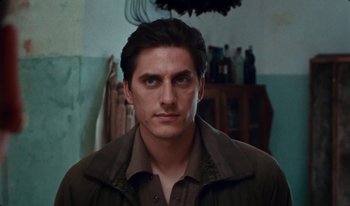 Movie still from “Martin Eden” (2019), directed by Pietro Marcello – A person wearing a jacket; Close Up shot, Low angle