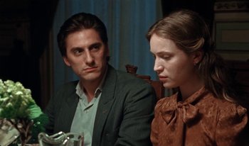 Movie still from “Martin Eden” (2019), directed by Pietro Marcello – A man and a woman sitting next to each other; Close Up shot, Over the shoulder angle