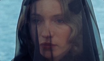Movie still from “Martin Eden” (2019), directed by Pietro Marcello – A person wearing a veil; Close Up shot, High angle