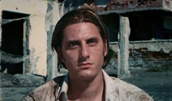 Movie still from “Martin Eden” (2019), directed by Pietro Marcello – A person with long hair; Close Up shot, Low angle