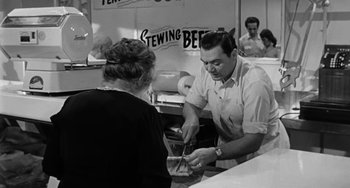 Movie still from “Marty” (1955), directed by Delbert Mann – A man and a woman are in a kitchen; Medium shot, High angle