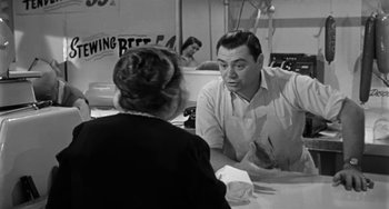 Movie still from “Marty” (1955), directed by Delbert Mann – A black and white photo of a man and a woman; Medium shot, Over the shoulder angle