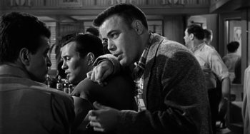 Movie still from “Marty” (1955), directed by Delbert Mann – Two men are sitting in a room together; Medium shot, Low angle