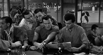 Movie still from “Marty” (1955), directed by Delbert Mann – A group of men sitting at a table drinking beer; Medium shot, High angle
