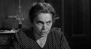 Movie still from “Marty” (1955), directed by Delbert Mann – An older woman with a cross on her neck; Close Up shot, Low angle