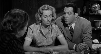 Movie still from “Marty” (1955), directed by Delbert Mann – A man and a woman sitting next to each other at a table; Medium shot, Over the shoulder angle